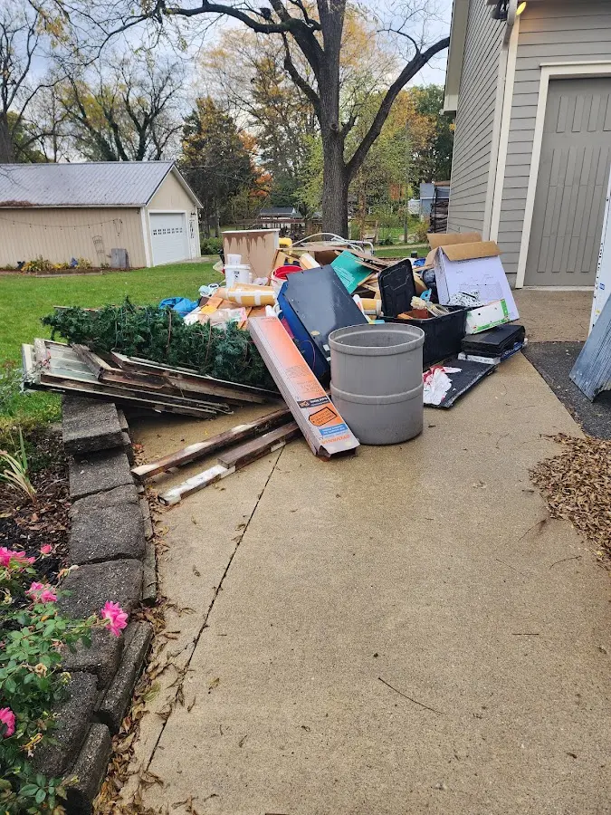 Dumpster being loaded with debris for Estate Cleanout Dumpster Rental in Fayetteville